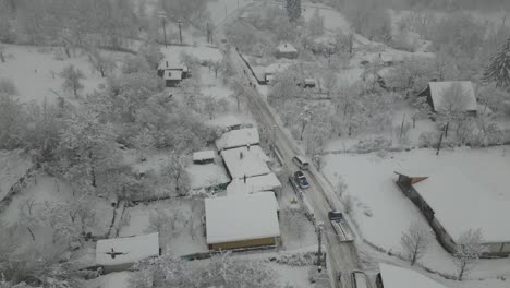 Narrow-road-with-snow-and-cars.-Drone-view