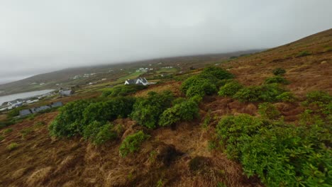 Fast-drone-shot-towards-a-beautiful-house-in-nature-on-Achill-Island,-Ireland