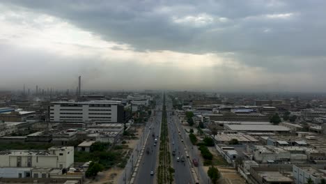 Toma-De-Tiempo-Del-Movimiento-Del-Tráfico-En-Una-Carretera-De-Dos-Vías-En-El-área-Industrial-De-Korangi,-Karachi,-Pakistán-En-Un-Día-Nublado