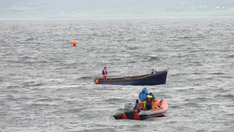 Irish-fishing-vessel-floats-through-in-front-of-safety-vessel-boat-in-galway-bay