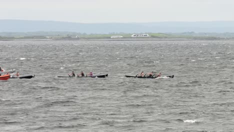 Tracking-follow-currach-boat-champions-racing-through-rocky-ocean-sea-water