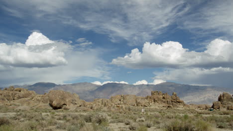 The-clouds-above-the-Alabama-Hills-in-Sierra-Nevadas-of-California,-Blue-Sky-and-Tilt-Down