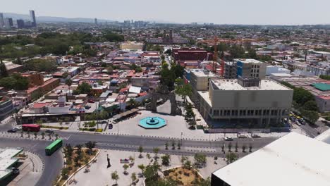 Daytime-low-level-drone-flyover,-downtown-train-station,-Zapopan-Metro,-Mexico