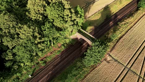 Aerial-View-Of-Railroad-Next-To-Rural-Field-Of-Crop-Circle-In-Warminster,-UK