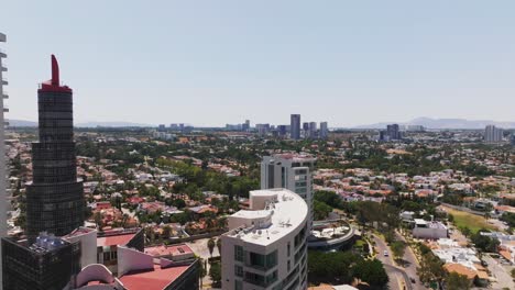Drone-aerial-view,-flying-by-glass-skyscrapers,-downtown-Guadalajara,-Mexico