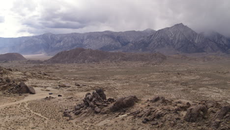 Wide-Drone-Aerial-above-the-Alabama-Hills-of-California,-Sierra-Nevada-Mountain-Range-in-the-background