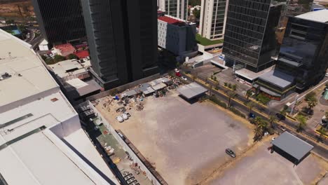 Downtown-drone-flyover-revealing-glass-skyscraper-buildings-cityscape,-Mexico