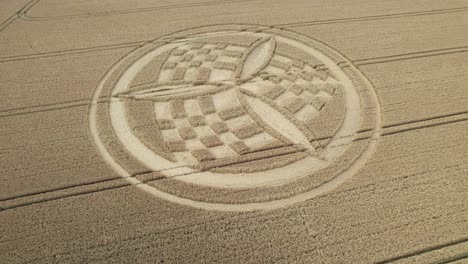 Establishing-aerial-view-over-South-Wonston-propeller-crop-circle-to-reveal-golden-Hampshire-wheat-field-countryside