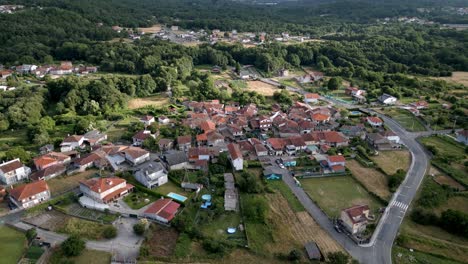 Aerial-dolly-tilt-down-above-red-orange-rural-roof-homes-in-lonoa,-spain