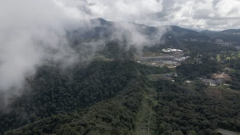 Low-cloud-aerial-flyover-of-Tanah-Rata-in-Cameron-Highlands,-Malaysia