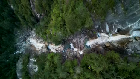 Aerial-topdown-ascent-of-Shannon-Falls-waterfall,-dusk,-Squamish,-BC,-Canada