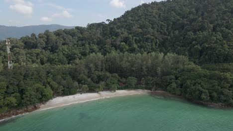 Aerial-orbits-Sandy-Skulls-Beach-in-Pasir-Tengkorak-Forest,-Langkawi