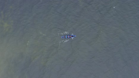 Drohne-Dreht-Sich-Oben-Und-Folgt-Currach-Bootsruderern-Im-Offenen-Ozeanwasser,-Das-Plätschert