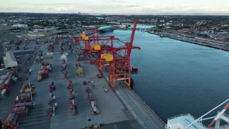 Aerial-top-down-shot-showing-industrial-cranes-at-port-of-Fremantle-with-parking-container-at-dusk