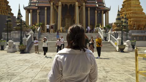 Slow-motion-shot-of-a-tourist-taking-in-the-experience-at-the-Emerald-Buddha-Temple