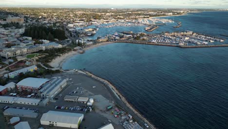 Aerial-flyover-port-area-of-Fremantle-in-Perth-City-with-marina-and-yachts-at-sunset-time,-Western-Australia