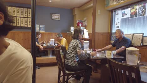 Japanische-ältere-Menschen-Essen-In-Einem-Traditionellen-Restaurant-In-Kyoto,-Japan,-Zu-Mittag.-Szenische-Filmische-Aufnahme-In-Einem-Blassen-Farbraum