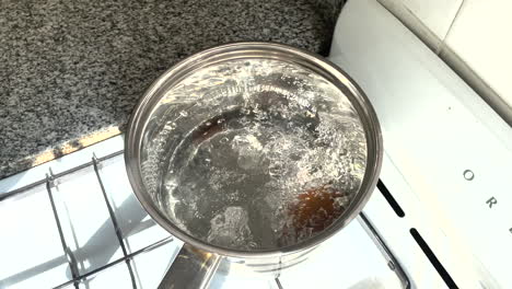 Water-boils-in-a-saucepan,-the-egg-is-boiled