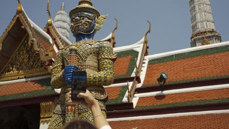 Slow-motion-shot-of-a-tourist-taking-a-photo-of-the-Temple-of-the-Emerald-Buddha