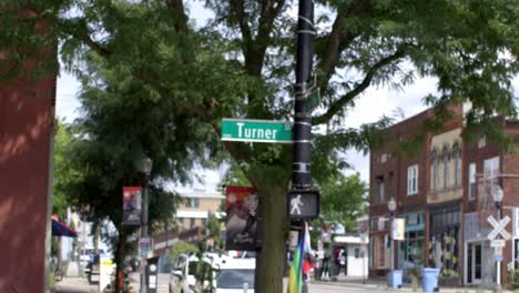Turner-Street-road-sign-in-Lansing,-Michigan-Old-Town-with-stable-establishing-video-shot-pulling-focus-and-in-slow-motion