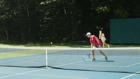 Couple-playing-tennis-in-Portland,-Mine