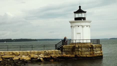 Couple-looking-over-Casco-Bay-harbor-with-dark-clouds
