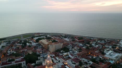 Aerial-Drone-Fly-Above-Coastline-of-Cartagena-Colombia,-Historic-Center-Avenue-and-Beach-Skyline-at-Sunset,-Travel-Destination-in-South-America