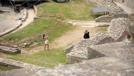 Visitor-to-the-Arena-of-Pula-capturing-photos-on-phone-of-her-friend