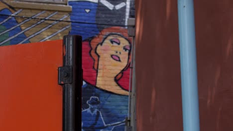 Close-of-mural-of-woman-in-Lansing,-Michigan-Old-Town-district-with-stable-pull-focus-video-shot