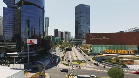 Low-level-drone-pulling-away,-crowded-downtown-city-with-people-and-cars,-Mexico