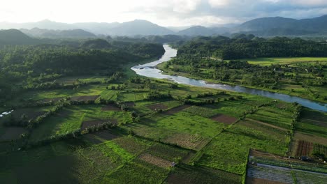 Philippines-nature-countryside,-scenic-river-valley-and-mountains,-sunset-aerial