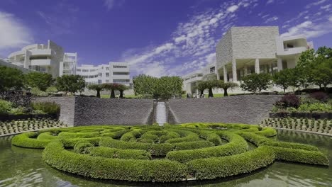 Static-shot-of-the-Central-Garden-at-the-Getty-Center-in-Los-Angeles-California-with-a-great-view-of-the-fountain-waterfall,-bushes,-buildings,-and-even-a-baby-duck-comes-into-frame