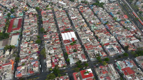 Aerial-birds-eye-view-of-house-rooftops-and-roads-in-Salvador-Diaz-neighborhood