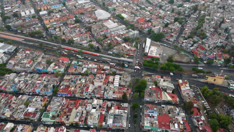 Aerial-birds-eye-view-Salvador-Diaz-neighborhood-house-buildings-rooftops-and-Mexico-cityscape