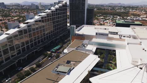 Flyover-drone-view,-downtown-shopping-mall-rooftop,-Guadalajara,-Jalisco,-Mexico