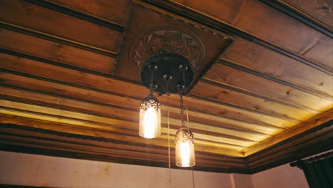 chandelier-hanging-from-a-wooden-ceiling.-8K
