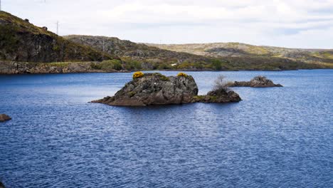 Wasser-Schimmert-Im-See-Embalse-Cardenas-Mit-Felsigen-Kleinen-Inseln-Und-Büschen