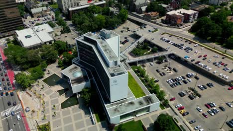 Rainbow-crosswalk-Hamilton-city-hall-aerial-drone-360-degree-panoramic-view-overlooking-the-back-parking-lot-to-front-entrance-with-twin-fountains-on-a-sunny-summer-day-with-stunning-lush-greenery