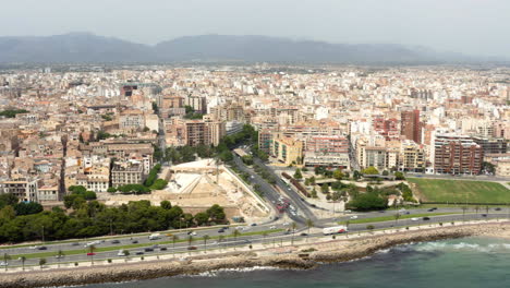 Car-traffic-on-busy-coastal-highway-with-Palma-city-center-behind