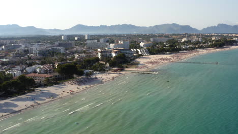 Sea-waves-washing-upon-beach-with-touristic-hotel-resorts-in-Alcudia