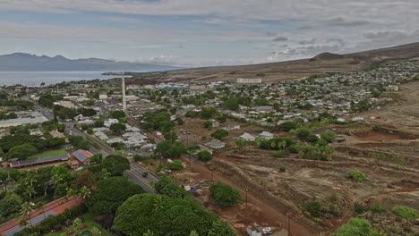 Lahaina-Maui-Hawaii-Aerial-v4-flyover-town-center-around-historic-landmark-Pioneer-Mill-Smokestack,-capturing-panoramic-views-of-islands-across-water-channel---Shot-with-Mavic-3-Cine---December-2022