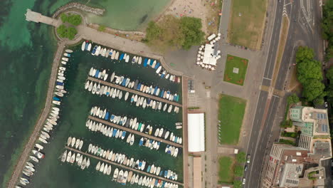 Top-down-aerial-shot-from-boat-marina-towards-a-sandy-beach