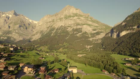 pushing-in-over-Grindelwald-Grund-with-unique-view-of-Mount-Mettenberg-on-a-summer-evening