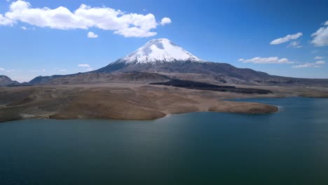 Aerial-view-over-of-the-scenic-Chungara-Lake-and-Parinacota-volcano,-Chile---reverse,-drone-shot