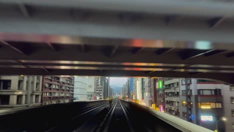Front-view-of-Taipei-metro-driving-through-scenic-cityscape,-POV