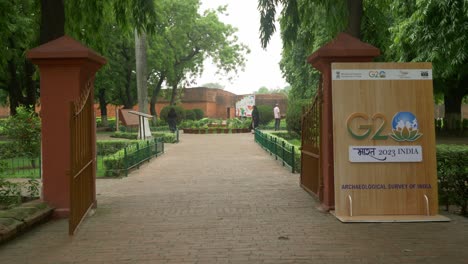 Wide-shot-of-the-banners-of-the-G20-nation-India-Summit-2023-put-up-at-the-entrance-gate-of-the-tourist-site-of-Nalanda-Mahavihara-ruins-in-Bihar-for-foreign-delegates-visiting-India