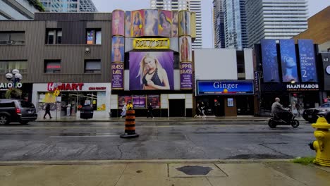 Toronto-Yonge-Bloor-Brass-Rail-adult-entertainment-tavern-open-since-1970s-as-the-oldest-erotic-strip-club-in-Canada-on-most-popular-location-surrounded-by-x-rated-massage-places-police-car-driving-by