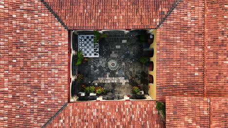 Aerial-view-rising-above-fountain-in-a-house-interior-courtyard,-Cordoba,-Veracruz,-Mexico