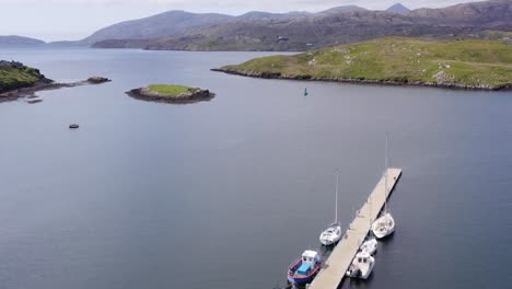 Drone-shot-of-the-pier-on-the-Isle-of-Scalpay,-an-island-near-the-Isles-of-Harris-and-Lewis-on-the-Outer-Hebrides-of-Scotland