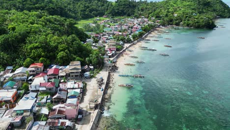 Third-world-fishing-village-in-the-Philippines,-turquoise-ocean-coastline
